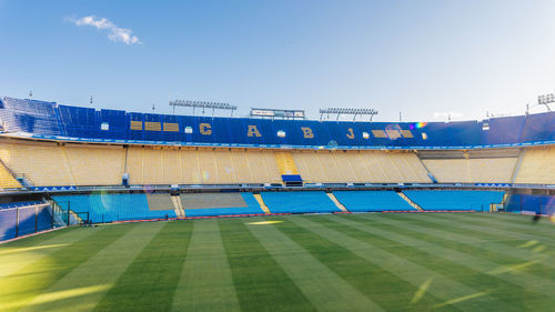 View of soccer field against clear blue sky