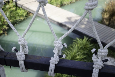 Close-up of swing tied up on rope