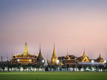 Temple with building in background at sunset
