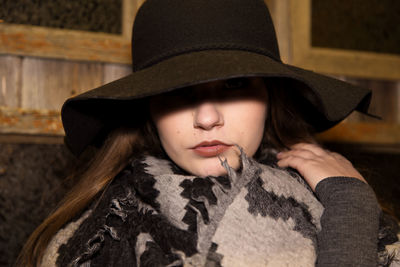 Close-up of woman wearing scarf and hat