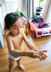 Cute girl playing with toy at home