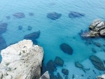 High angle view of rock formation in sea