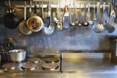 Clothes hanging on metal in kitchen