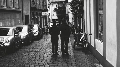 Rear view of people standing on road
