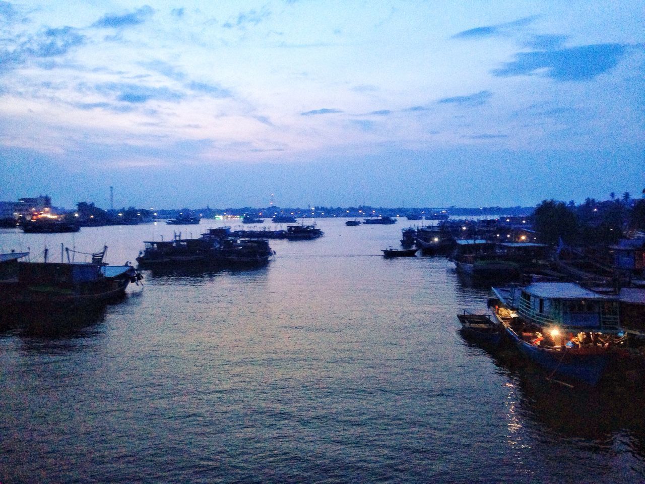 SAILBOATS IN SEA AT DUSK