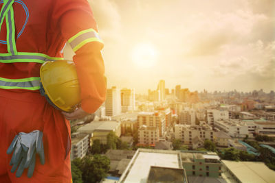 Man standing in city against sky