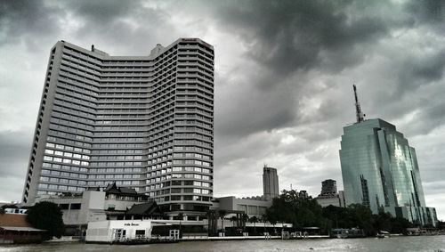 City skyline against cloudy sky