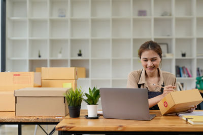 Businesswoman using laptop at table