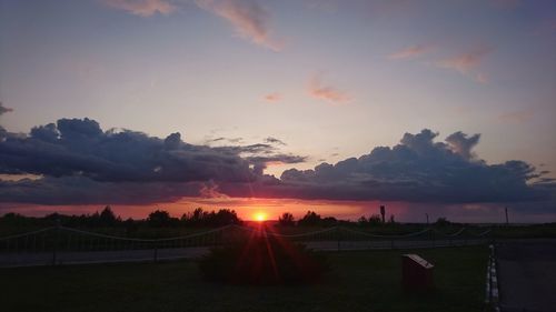 Scenic view of silhouette field against sky during sunset