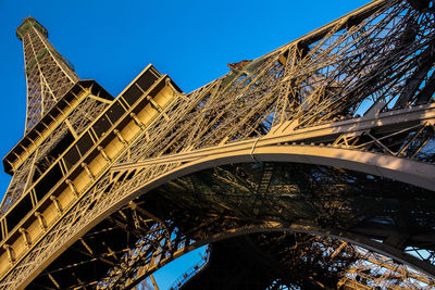 Low angle view of bridge against blue sky