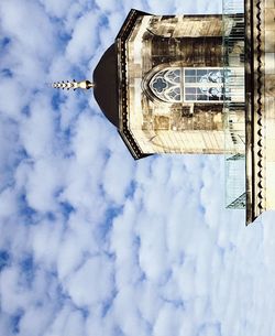 Low angle view of building against cloudy sky