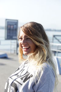 Smiling young woman standing outdoors