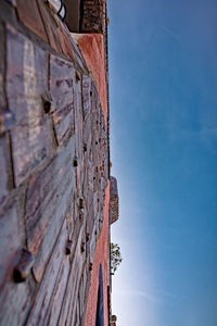 Low angle view of old building against blue sky