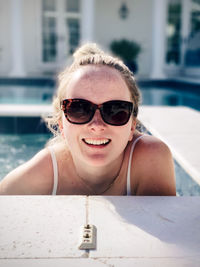 Portrait of smiling young woman in swimming pool