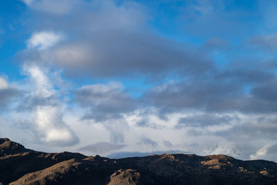 View of mountain range against cloudy sky