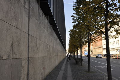 Sidewalk by buildings in city