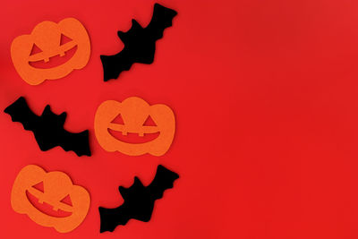 Close-up of red halloween against orange background
