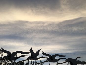 Low angle view of silhouette plants against sky at sunset