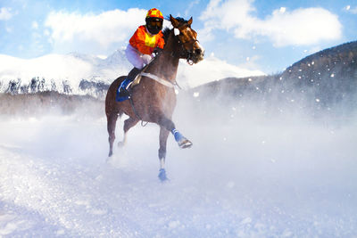 Man riding horse in snow