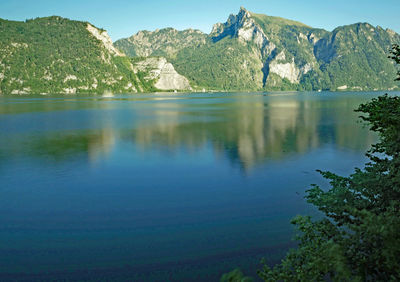 Scenic view of lake and mountains against sky