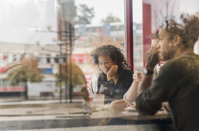 Group of people looking through window
