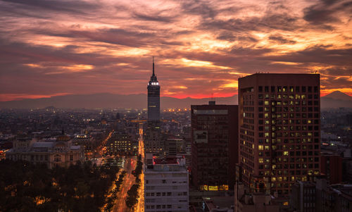 View of buildings against cloudy sky during sunset