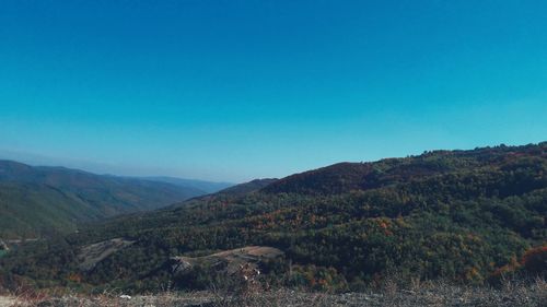 Scenic view of mountains against clear blue sky