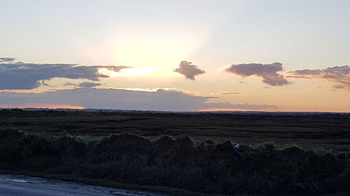 Scenic view of land against sky during sunset