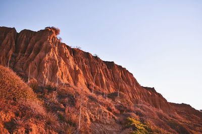 Low angle view of rock formation against sky