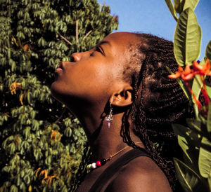 Portrait of woman with flowers on tree