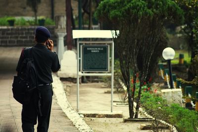 Rear view of soldier walking on footpath