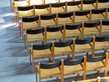 Empty chairs and table in row