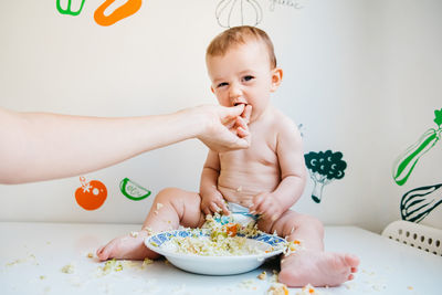 Cute boy eating food at home