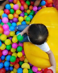 High angle view of girl playing with toy