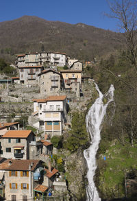 Buildings in town against mountains