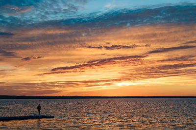 Scenic view of sea against sky at sunset