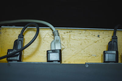 Close-up of telephone booth on table against wall