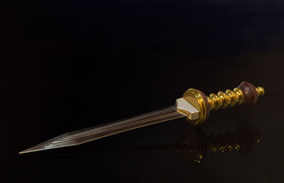 Close-up of sword over black background