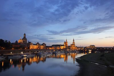 View of city lit up at sunset