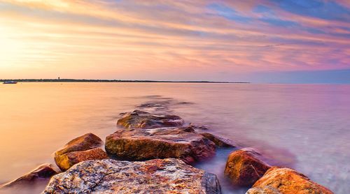 Scenic view of sea against sky at sunset