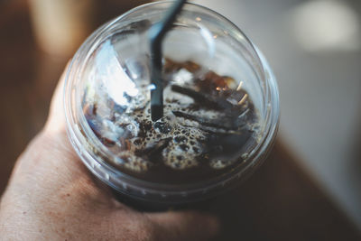 Close-up of hand holding cigarette