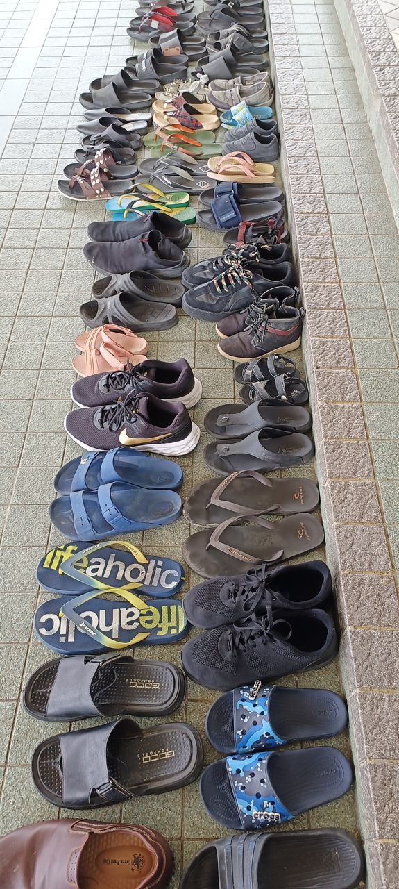 high angle view, shoe, multi colored, footwear, blue, art, variation, in a row, large group of objects, day, flooring, arrangement, retail, no people, outdoors, abundance