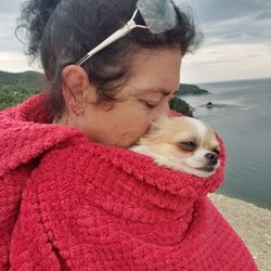 Portrait of woman with dog at beach