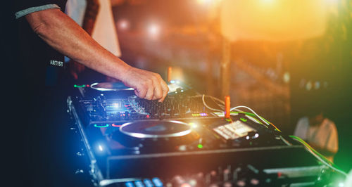 Dj mixing while streaming a online party festival during coronavirus time - soft focus on hand 