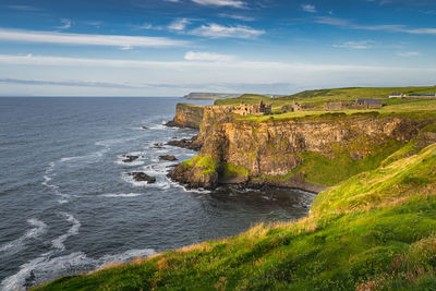 Spectacular coastline, dunluce castle located on edge of the cliff, northern ireland