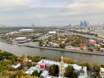 High angle view of river amidst buildings in city against sky