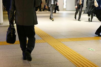 Low section of people walking on subway station