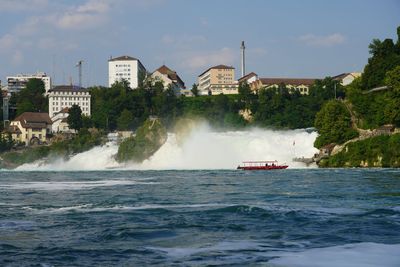 Scenic view of waterfall against sky