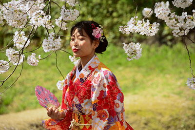 Portrait of woman with pink flowers