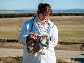 Woman with dog on field